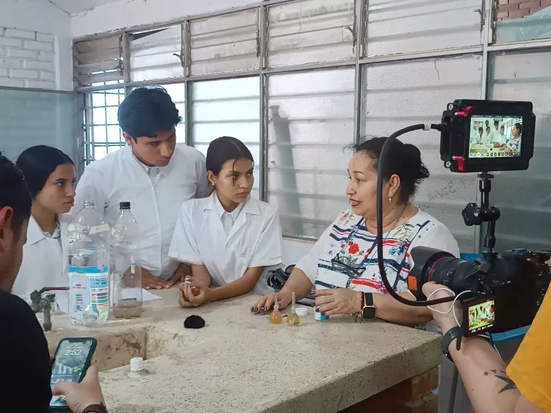 48 equipos clasificaron al Circuito Nacional de las Olimpiadas STEM+ Colombia 2025 Profesora con alumnos en experimento que está siendo grabado