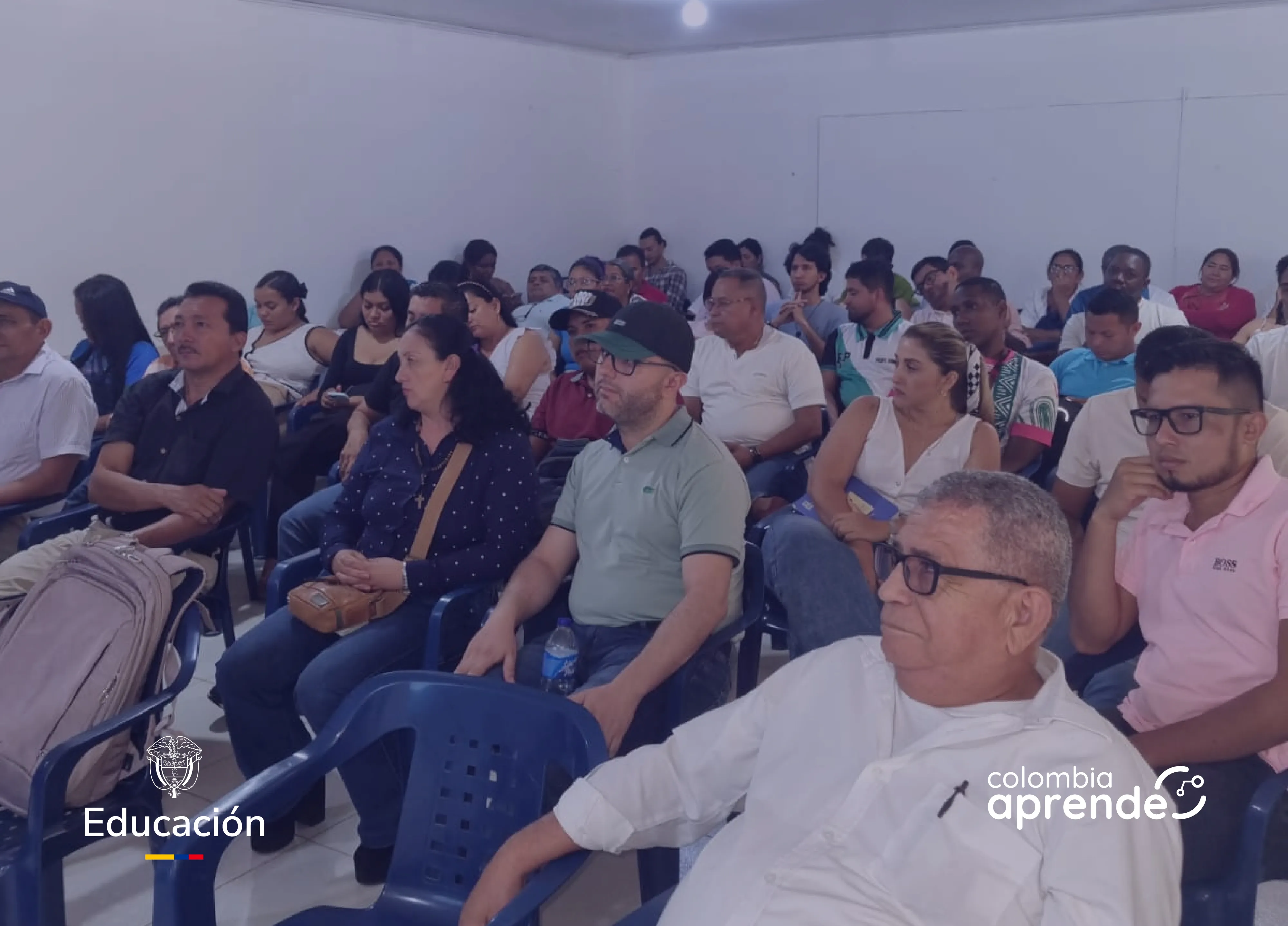 Grupo de docentes en un salón recibiendo capacitación sobre el uso del Portal Colombia Aprende
